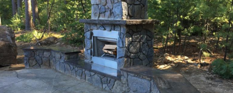 Outdoor Fireplace Feature by H&M Landscaping.