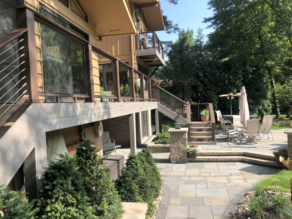 Cleveland Landscaping Company Project Multi-level Stone Patio Featuring Stone Pillars & Elevated Deck