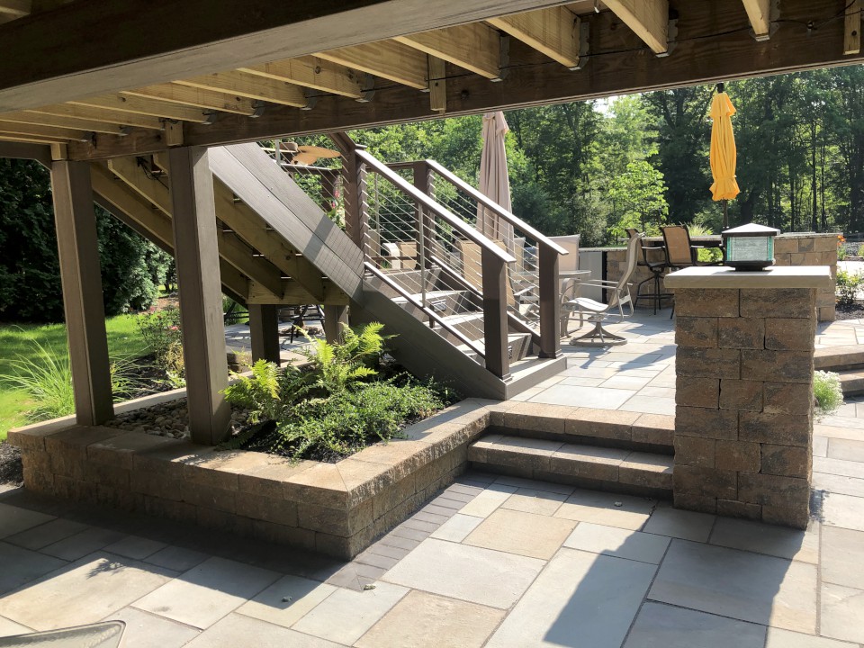 Cleveland Landscaping Company Project Stone Patio with Raised Stone Planting Bads & Stairs to Deck