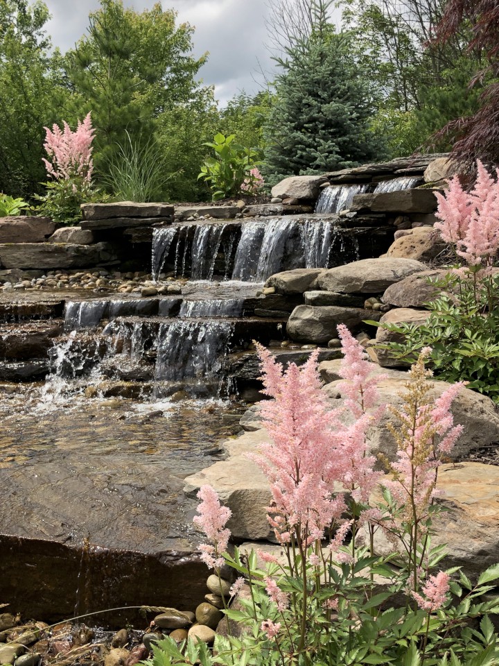 Cleveland Landscaping Company Project Backyard Waterfall Feature with Natural Stone and Plantings
