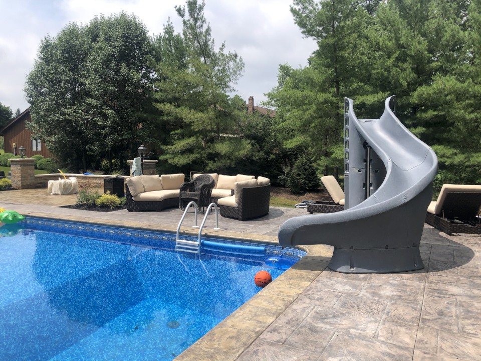 Cleveland Landscaping Company Project Backyard Pool with Slide and Outdoor Seating Area