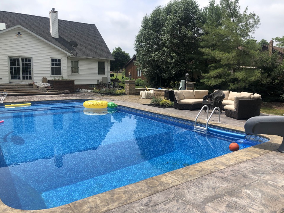 Cleveland Landscaping Company Project Pool Surrounded by Patio with Outdoor Seating Wall