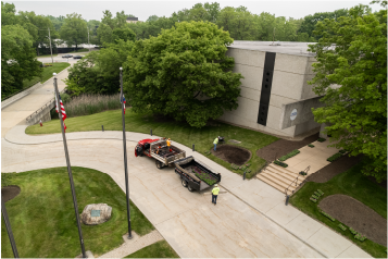 commercial-landscaping-maintenance-ohio Landscaping crew performing maintenance on a commercial property with lawn and trees