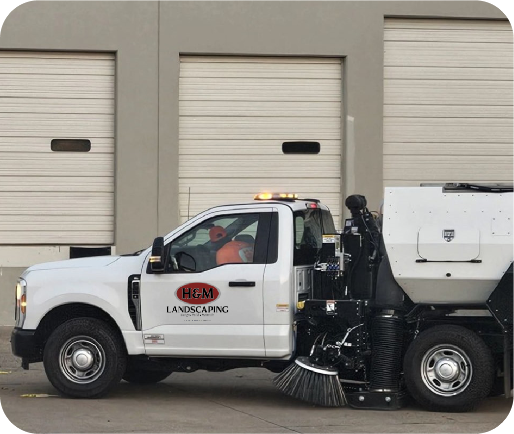 hm-landscaping-sweeper-truck-profile H&M Landscaping commercial sweeper truck parked outside facility, displaying professional fleet vehicle for parking lot sweeping and portering services in Cleveland